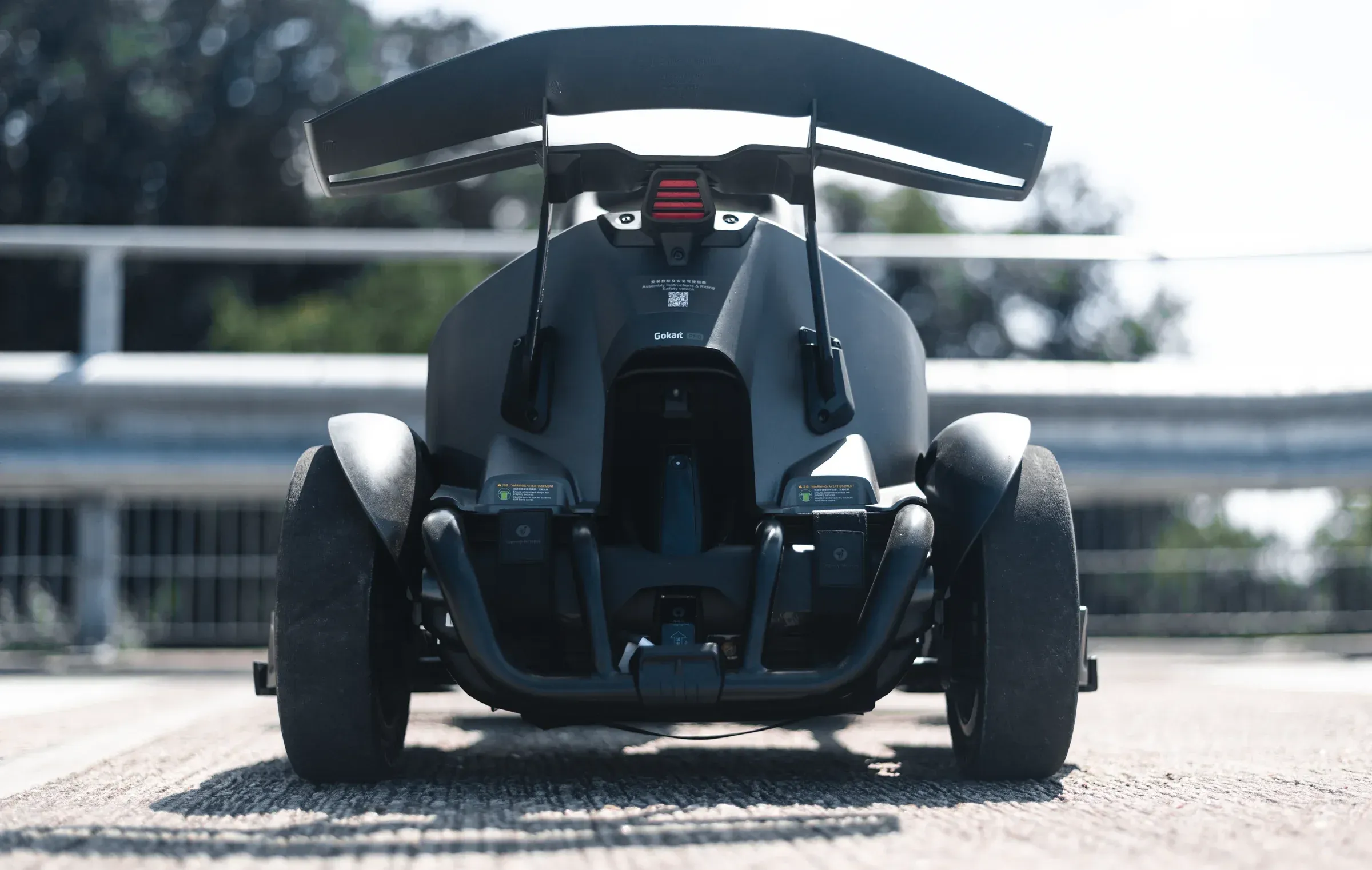 Tight action frame of go-karts racing, asphalt and tyre texture foregrounded